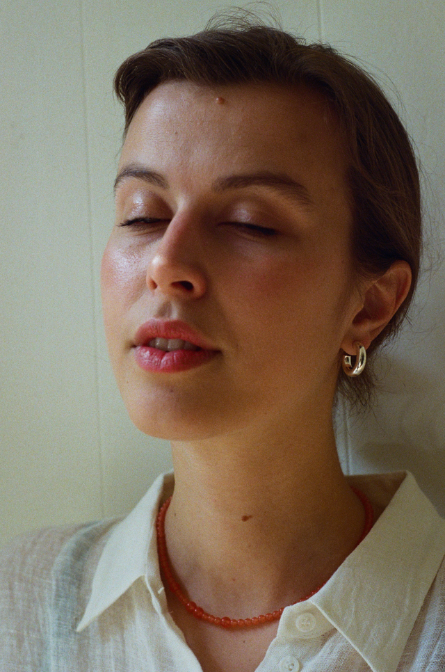 Sterling silver jewelry as silver hoop earrings seen on woman