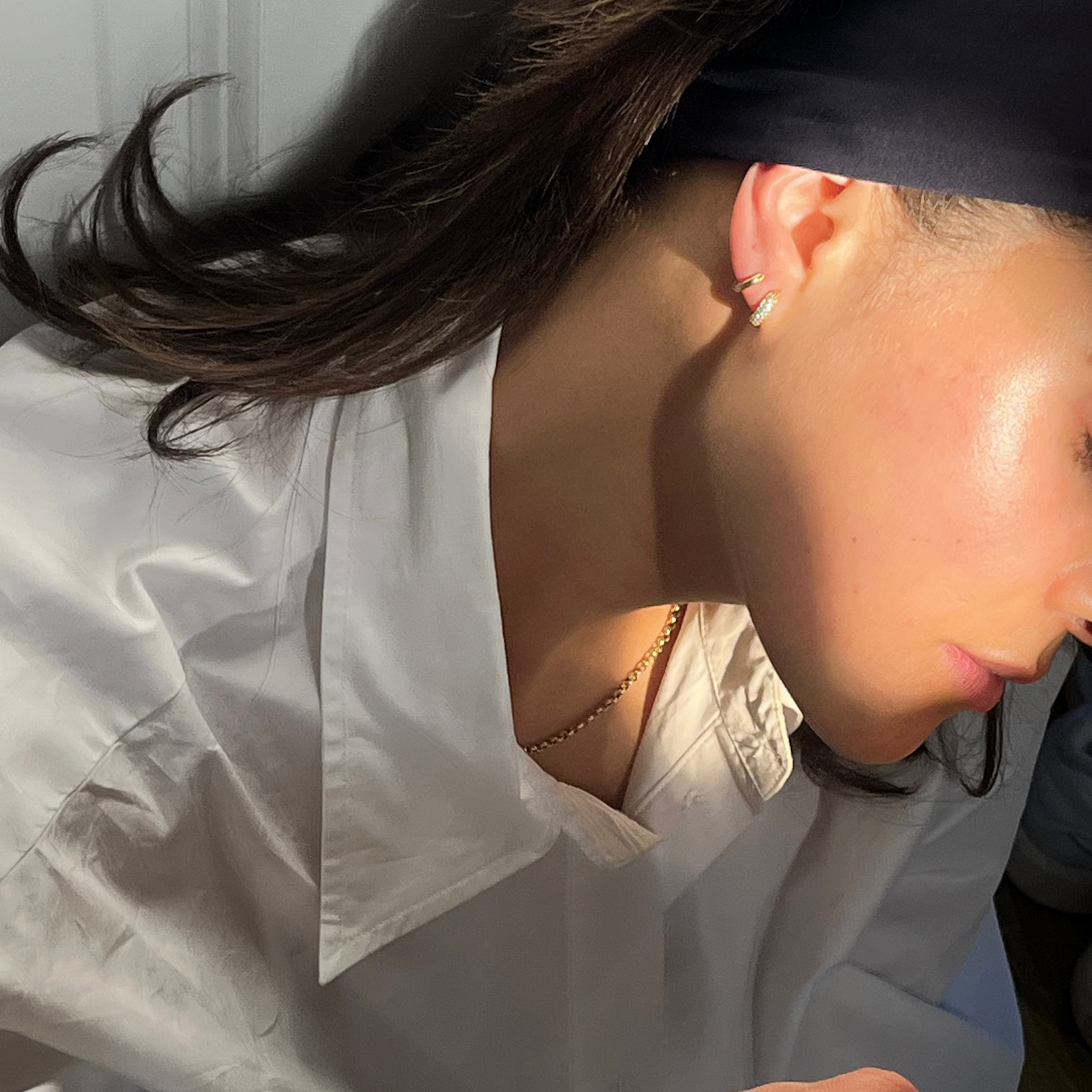 woman wearing small gold hoop earrings