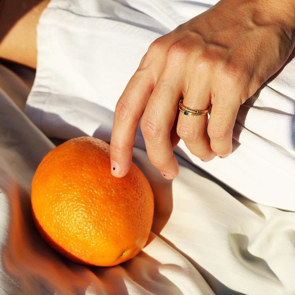 a close up of a person holding an orange 