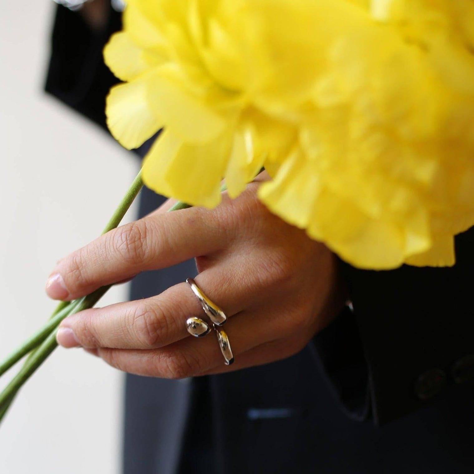 a close up of a person holding a flower