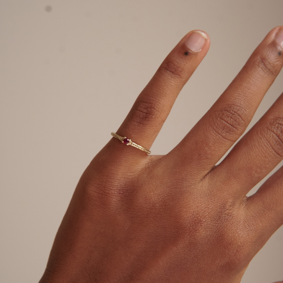 Gold ring with stone. Available in red, green and blue.