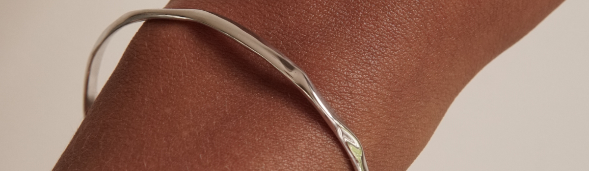 Silver cuff bracelet with an uneven design
