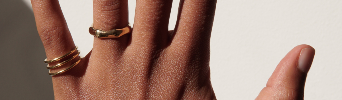 Gold ring combination with a bold bamboo ring and triple ring